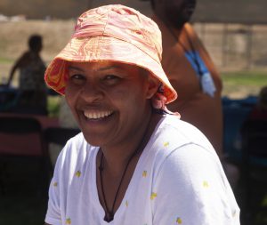 Smiling Black woman at HCA event in the sun