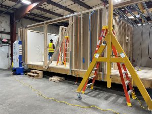 Wood framed box like structure on factory floow